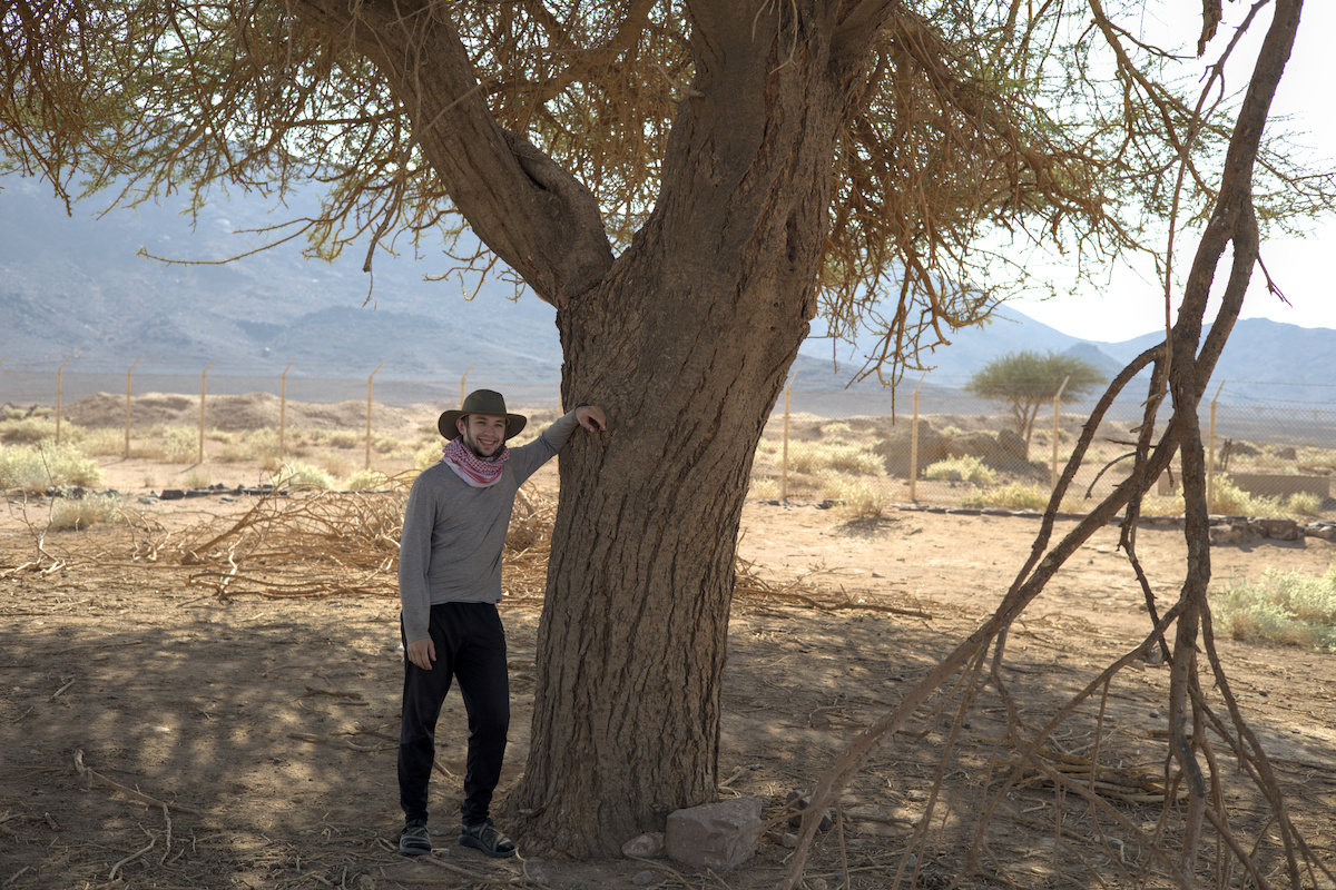 Seth posing with a tree growing in a buried reservoir