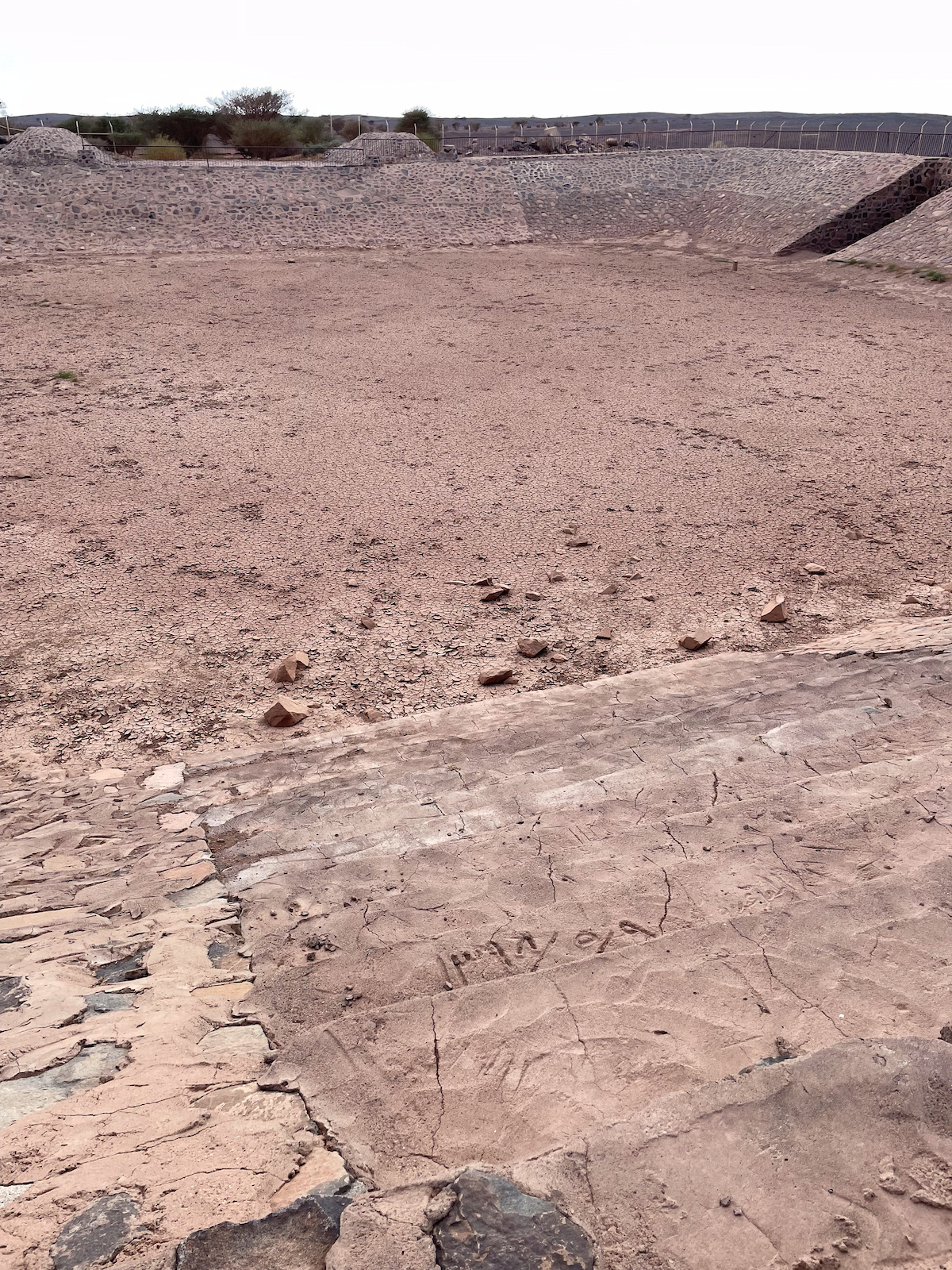 A reservoir with Arabic writing on a stair